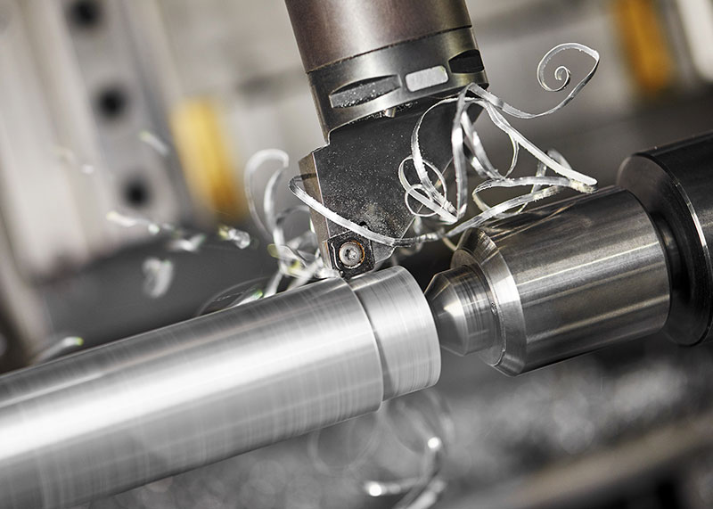 CNC milling cutter finishing a metal surface with swarf